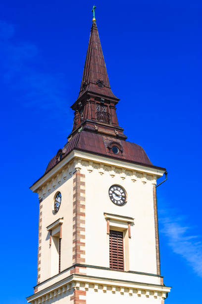 Church tower with clock against a blue sky