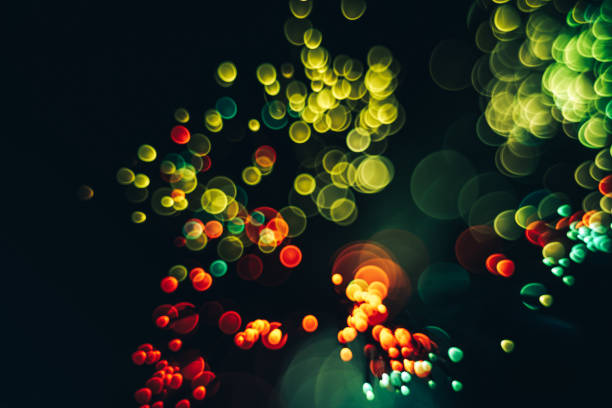 istock Beautiful optical abstract color bokeh in the darkness background. 1187654857
