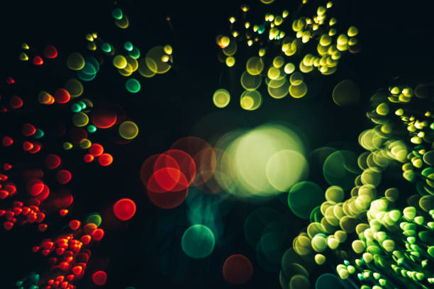 istock Beautiful optical abstract color bokeh in the darkness background. 1187654894
