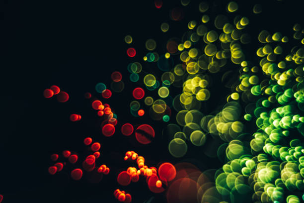 istock Beautiful optical abstract color bokeh in the darkness background. 1187654948