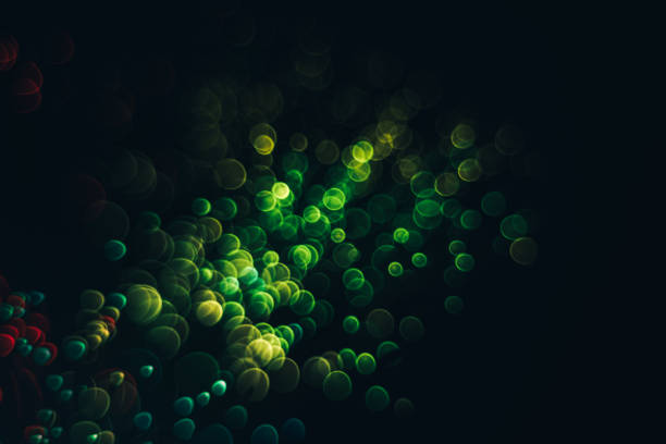 istock Beautiful optical abstract color bokeh in the darkness background. 1187655538