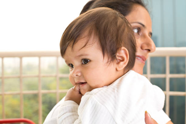 Happy mother with cute baby son at balcony