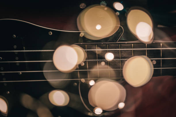 istock Electric bass guitar blurred background with beautiful bokeh. 1187657387