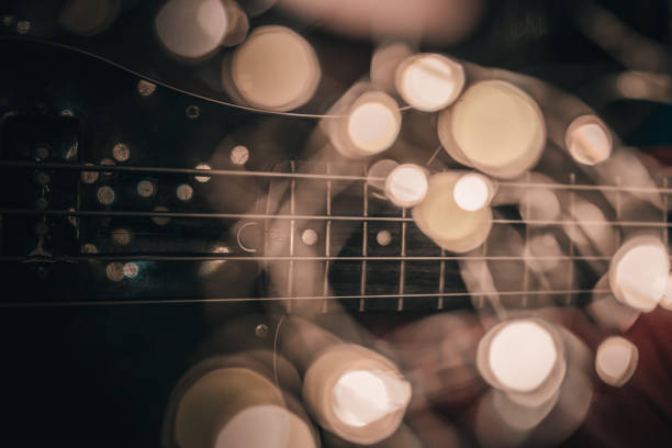 istock Electric bass guitar blurred background with beautiful bokeh. 1187657388