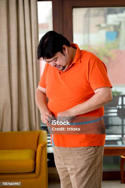 Obese Man Measuring His Belly Stock Photo - Download Image Now - Dieting, Overweight, Fat - Nutrient