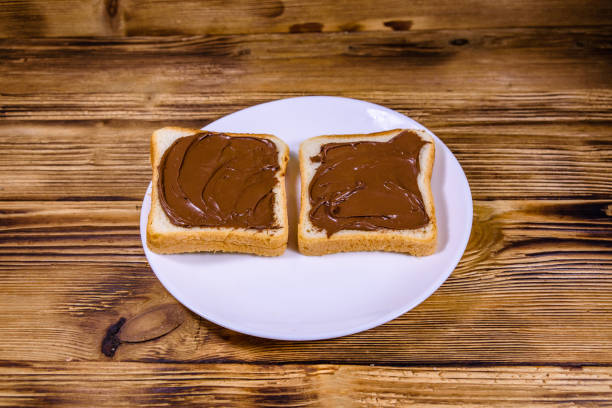 istock Two sandwiches with chocolate spread on a white plate 1187660993