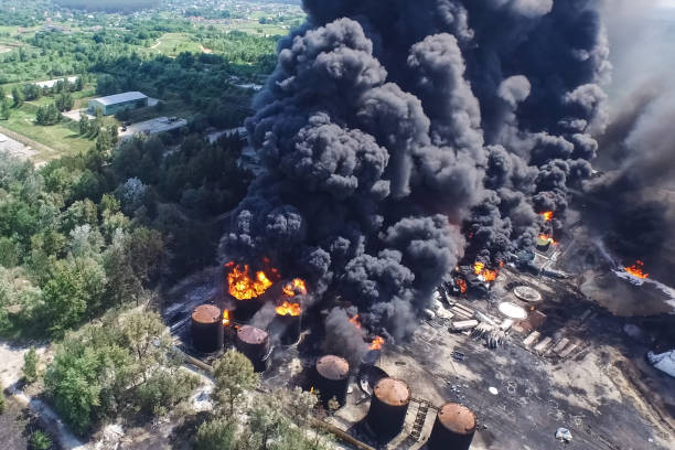 Oil storage fire. The tank farm is burning, black smoke is combu stock photo