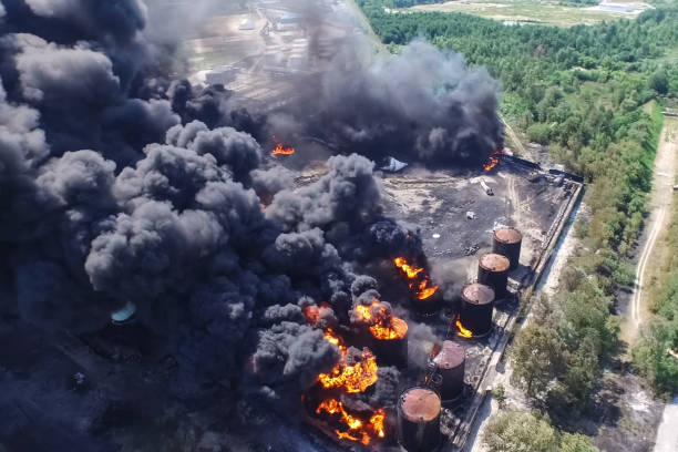 istock Oil storage fire. The tank farm is burning, black smoke is combu 1187661073