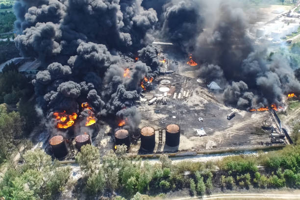 istock Oil storage fire. The tank farm is burning, black smoke is combu 1187661076