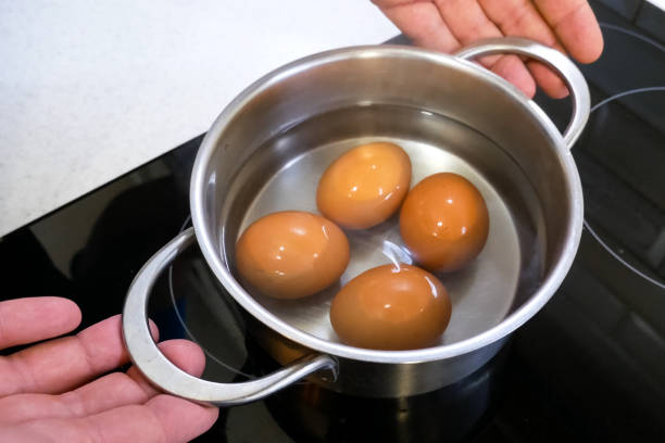 istock Boiled eggs in pan are removed from the stove. 1187661100