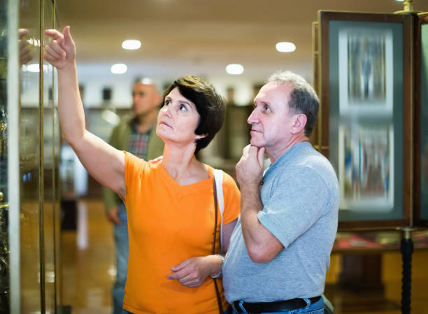 istock Romantic elderly couple interested in objects of applied arts in museum 1187661466