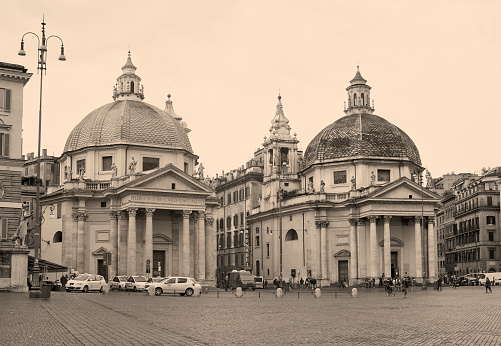 Rome, Italy - March 26, 2014: Baroque churches Santa Maria in Montesanto and Santa Maria dei Miracoli on Piazza del Popolo