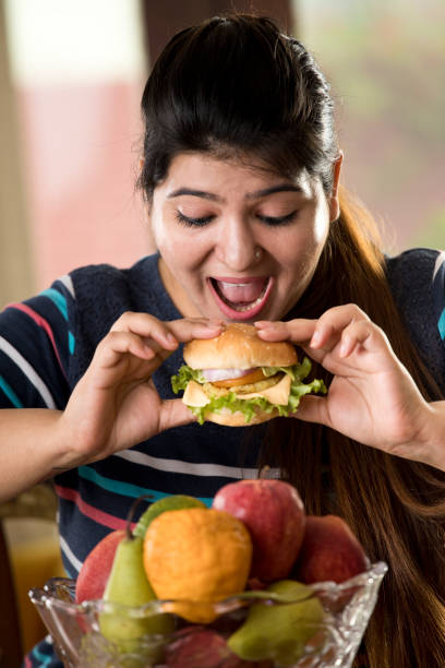 woman eating a fast food burger