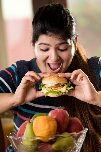 woman eating a fast food burger