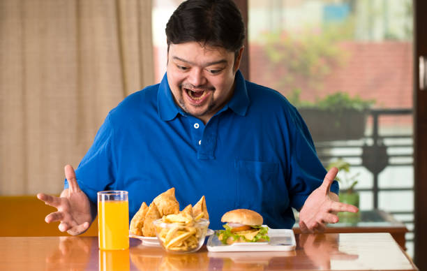istock Excited fat man with plate of samosa 1187664939