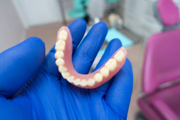 istock removable denture in the hands of a doctor 1187665422