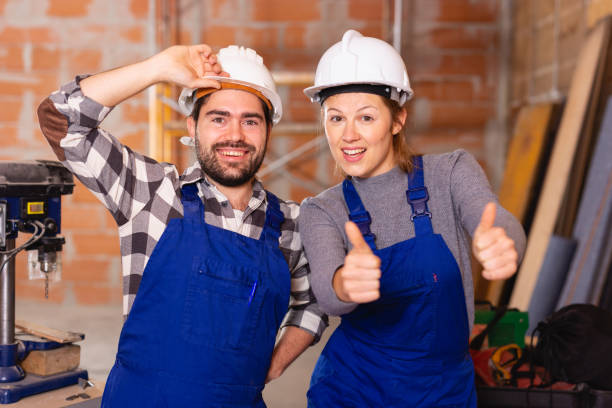 istock Portrait of two successful workers in uniform inside brick cottage 1187665486