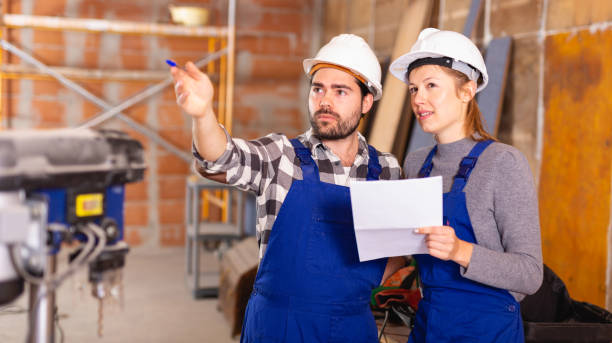 istock Workers man and woman discuss construction plan 1187665490