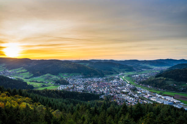 Germany, Romantic orange sunset sky decorating beautiful view over tree tops of black forest village haslach im kinzigtal valley surrounded by endless green forest