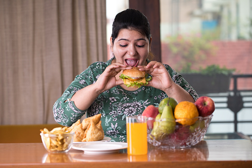 woman eating a fast food burger