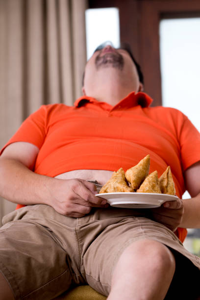 Overweight man sleeping after eating fried samosa