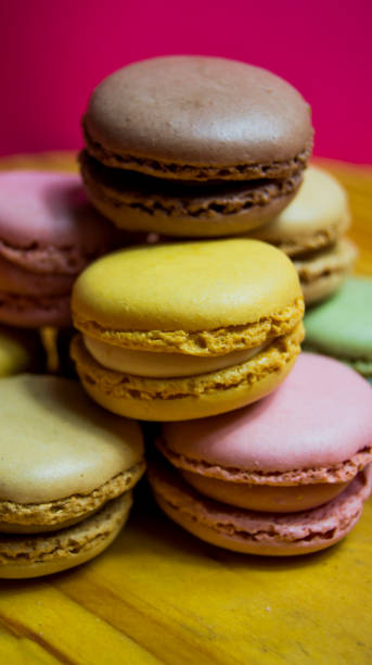 istock Colored macarons isolated on wooden dish, typical French dish 1187668451