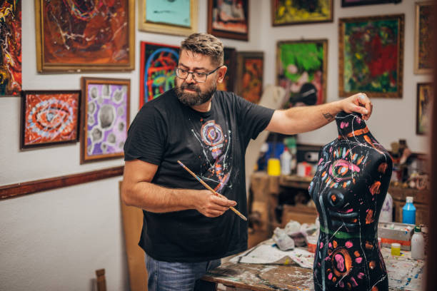 istock Creative male artist working in art studio 1187668787