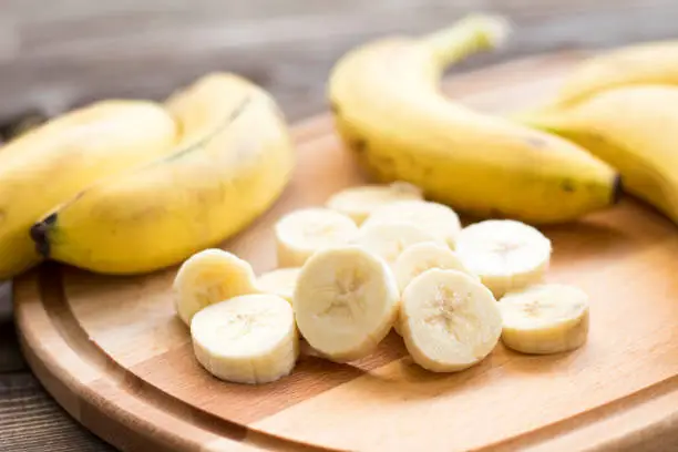 Photo of Fresh bananas on wooden background.