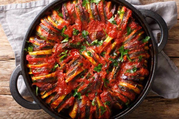 istock Mediterranean baked various vegetables in tomato sauce close-up in a pan. Horizontal top view 1187669752