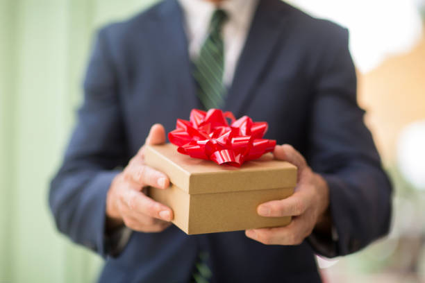 istock Unrecognazable well-dressed man holding a gift. 1187670691