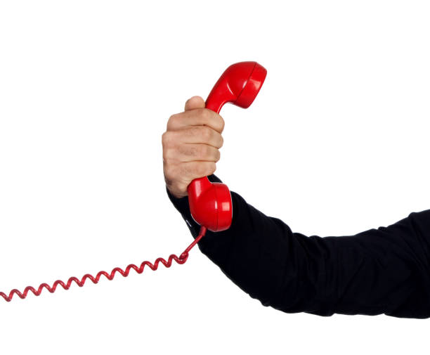 istock Male hand holding a red phone 1187673844