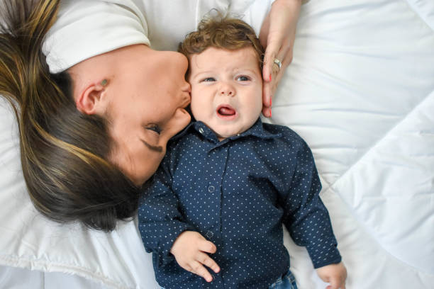 istock Mother with baby on bed having good time 1187675205