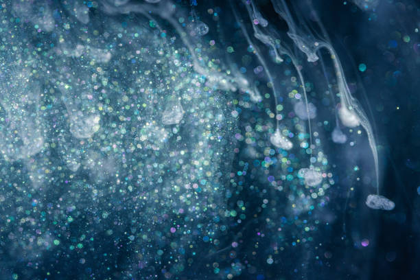 istock Shiny acrylic ink with glitter floating in the water 1187677613