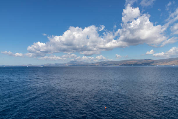 istock Ocean and clouds reflected with Greece continental in background from Hydra Island 1187681256