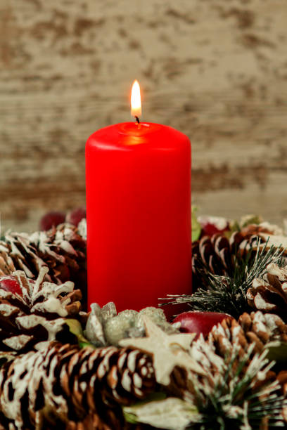 istock Red candle lit and pinecones for Christmas 1187681427