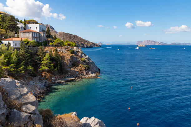 istock Beach with buildings, rocks and vegetation in Hydra Island 1187682547