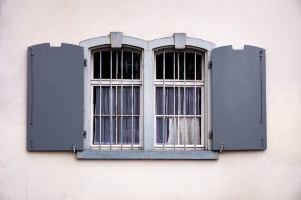 istock Gray barred wndows with shutters 1187682616