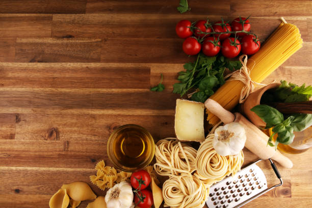 istock Pasta, vegetables, herbs and spices for Italian food on rustic table 1187683541