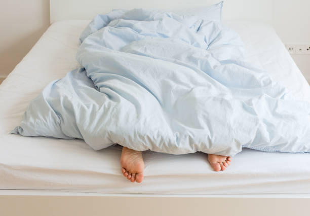 istock Woman sleeping on a white bed 1187684178