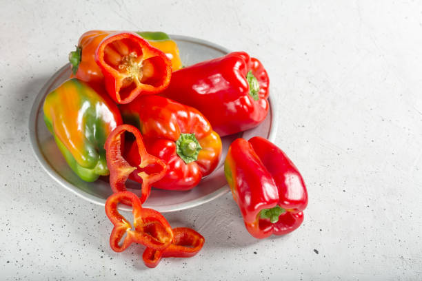 istock Sweet fresh red peppers on gray background 1187685256