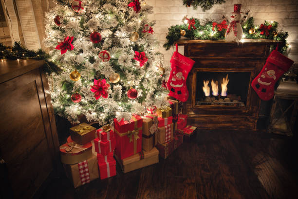 istock Decorated Christmas Tree Near Fireplace at Home 1187685685
