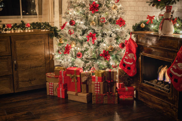 istock Decorated Christmas Tree Near Fireplace at Home 1187686204