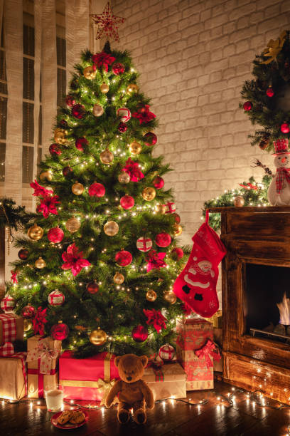istock Decorated Christmas Tree Near Fireplace at Home 1187686236