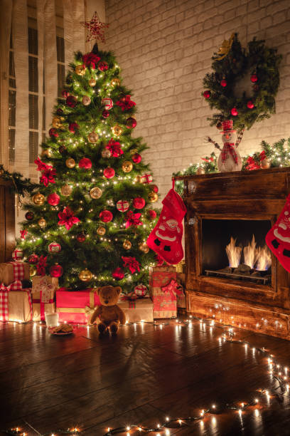 istock Decorated Christmas Tree Near Fireplace at Home 1187686240