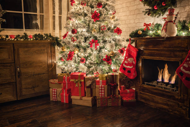 istock Decorated Christmas Tree Near Fireplace at Home 1187686266