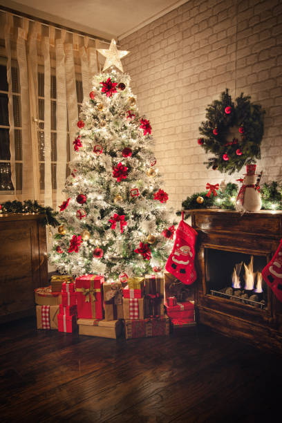 istock Decorated Christmas Tree Near Fireplace at Home 1187686274