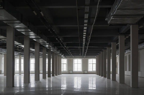 istock Empty huge open space in old factory building with rows of columns, big windows and pipes on the ceiling 1187686459
