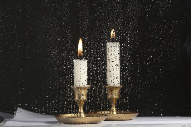 Drops of water on the glass and candles in vintage  candlesticks.