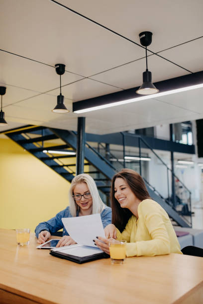 istock Two business people discussing business strategy using digital tablet 1187687772