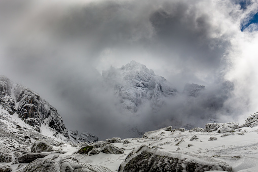 Summit in the clouds with dramatic sky at the Rila mountain in Bulgaria, Maliovica.